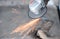 Close up of a man sharpen an ax using electric grinder