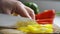 Close Up Of Man Slicing Yellow Pepper