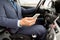 Close up of man with smartphone driving car