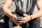 Close up of man with smartphone and earphones wire