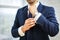 Close-up of man in suit with watch on his hand fixing his cufflink. groom bow tie cufflinks