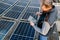 Close up of man technician using application. Checking solar panel setup.