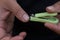 Close up of man trims his fingernails using a metallic pair of nail clippers