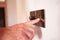 Close Up Of Man Turning On Electric Light Switch