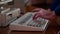 Close-up of man typing on retro keyboard. Media. Man uses old computer, typing on old keyboard. Old computer equipment