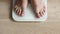 close up of Man walking on scales measure weight. male wal checking BMI weight loss. human barefoot measuring body fat