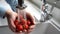 Close up man washing fresh strawberries