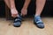 Close up of a man wearing or tying his wall climbing shoes