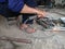 close up, man welding broken chair at his workshop