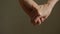 Close up man and woman hand touching holding together on blurred background.