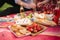 Close up of man and woman has non alcoholic picnic outdoors. Strawberry, lemonade, bread and other snacks