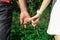 Close-up of a man and a woman`s hand. Hands are held together with the little fingers