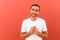 Close up of a man wondering isolated on red background