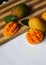 Close up of Mangoes on wooden chopping board