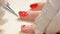 Close up manicurist painting on nails.