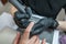 Close-up of a manicurist removing varnish from a client`s nails using a router