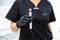 Close-up maniple of hydro-peeling apparatus in the hands of a beautician doctor.