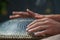 Close-up of a mans hand playing on modern musical instrument Hand pan or Vadjraghanta or metal tongue drumon, selective focus