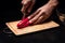 Close up of mans hands chopping bell pepper