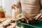 The close -up of the mans hands is watering planted tomato seeds. The process of planting tomato seeds in peat