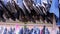 Close up of many blue jeans hanging on a rail