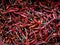 Close up many group of dried red chili peppers at street food market.