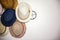 Close up of many summer hat on a white wall. Straw Hats for summer hanging on white wall in hotel. Accessories and travel concept