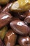 Close up marinated kalamata olives, product of Greece and Cyprus in oil as background. vertical banner. Macro