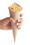 Close up of Marwadi Bhujiya Indian namkeen snacks  in brown paper cone holding in hand isolated over white