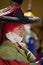 A close up of a Masked performer in traditional Ladakhi Costume