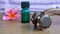 Close up of massage tools, massage oil and pink frangipani flowers on a wooden table