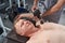 Close up masseur doing chest muscles massage with percussion tool