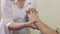 Close up of masseuse hands make massage of hand wrist to adult man. Healing