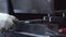 Close-up of a master worker in protective gloves bending a metal workpiece on hydraulic sheet bender at a factory