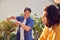 Close Up Of Mature Asian Couple At Work Watering And Pruning Plants In Garden At Home