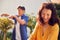 Close Up Of Mature Asian Couple At Work Watering And Pruning Plants In Garden At Home