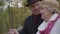 Close-up of a mature Caucasian couple standing next to the handrails and talking. Senior man and woman dressed in