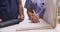 Close-up of mature female nurse writing in a patient\'s folder