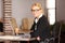 Close up of a mature lawyer smiling. Working at a desk. Laptop