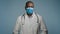 Close-up mature male doctor surgeon in protective mask looks at camera man experienced hospital worker posing in studio
