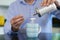 Close Up Of Mature Man Adding Sugar To Hot Drink At Home