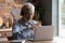 Close up mature man wearing headphones using laptop, video call