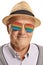 Close-up of a mature man wearing a pair of rainbow glasses