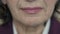 Close up of mature woman\'s neck, lips, smiling. Slowly
