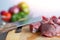 Close up of meat cut into beef stew cubes chunks on wooden board. Cooking dinner on kitchen table concept