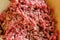 Close up meat grinder or mincing-machine with mincemeat in. Showing the forcemeat process.