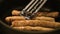 Close-up of meat sausages being fried in a frying pan. Concept. Close up view of sausages being fried in a pan. Pan with