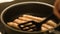 Close-up of meat sausages being fried in a frying pan. Concept. Close up view of sausages being fried in a pan. Pan with