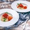 Close Up meatballs in tomato sauce with spaghetti on large white plates