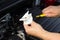 Close-up, the mechanic checks the oil level in the car